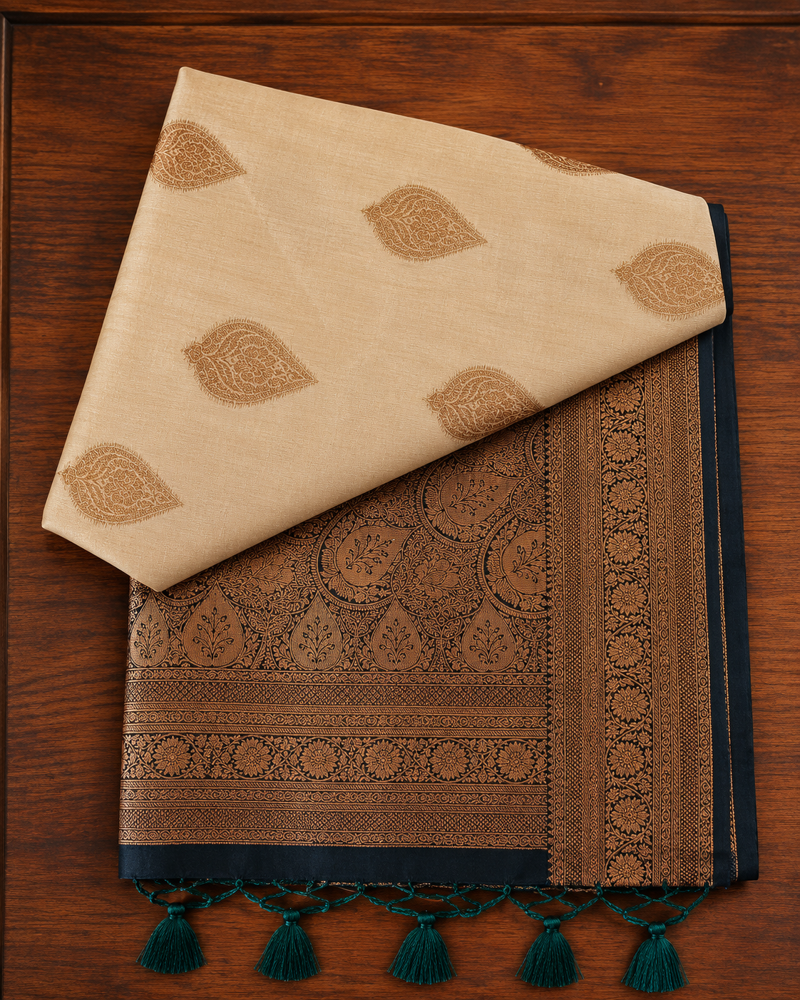 Cream-beige butter silk saree featuring a heavily woven navy blue antique zari pallu with tassels from Thambai online store.
