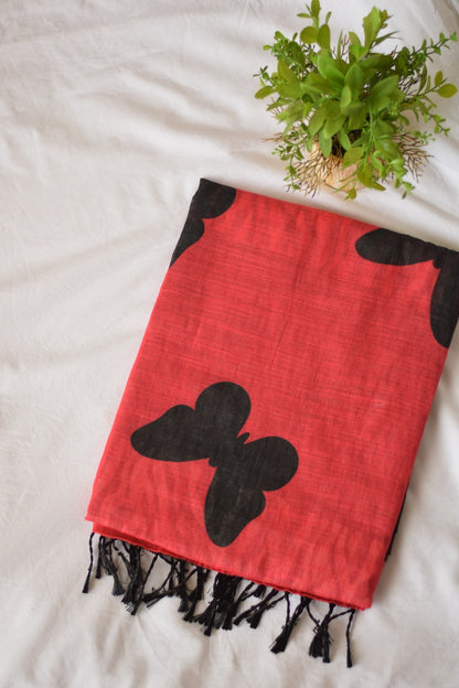 Chanderi Linen Cotton saree with black butterfly designs on a white surface with a plant.