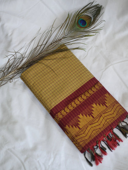 Traditional woven fabric with a peacock feather on a white background
