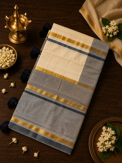 Grey and off-white Kasavu cotton saree with gold zari stripe borders and dark tassels by Saree from Thambai, styled for modern festive, casual, or office wear.