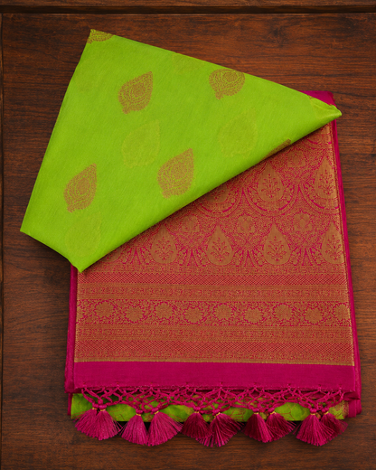 Lime green and magenta pink butter silk saree with traditional golden zari pallu and tassels from Thambai online store.