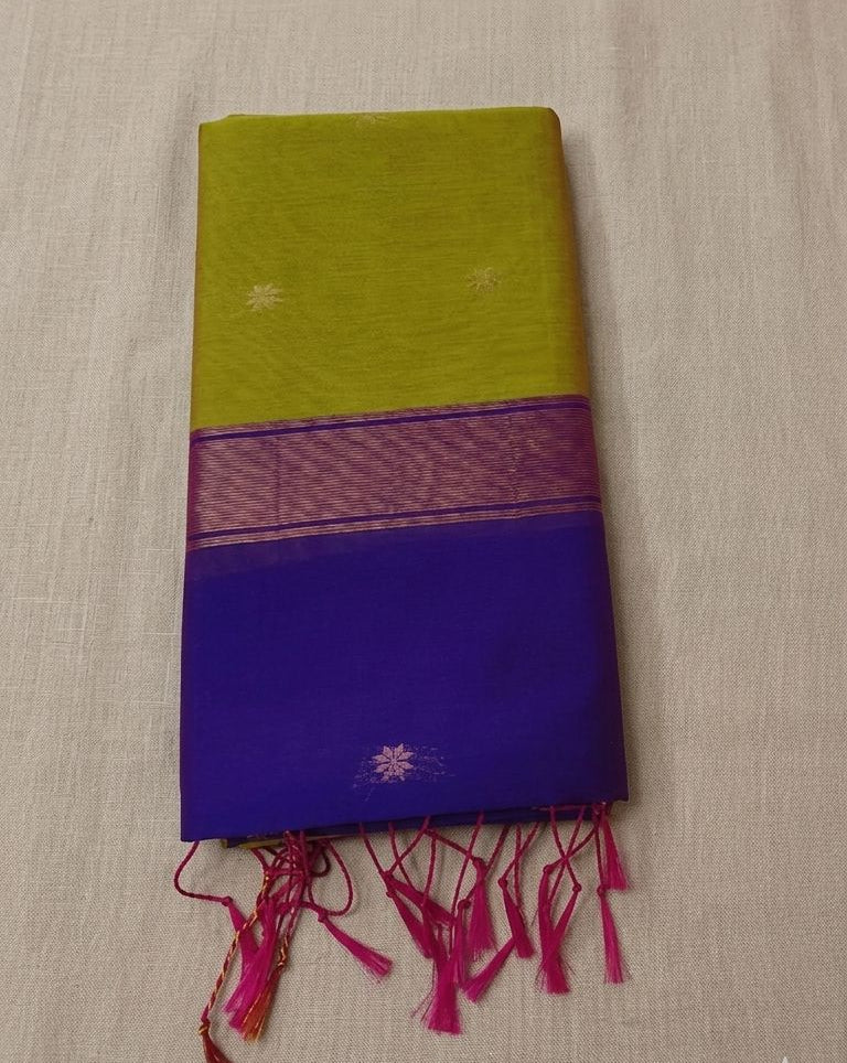 saree from thambai's Maheswari Cotton Green and purple saree  with pink tassels on a beige background