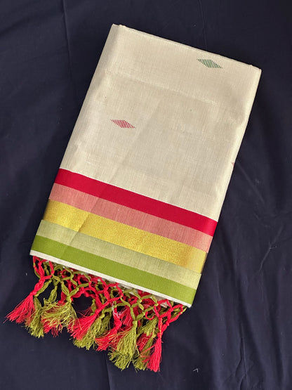 Paarijaatham_Multicolor Border Kerala traditional tissue set saree from saree from thambai with colorful stripes and tassels on a dark background