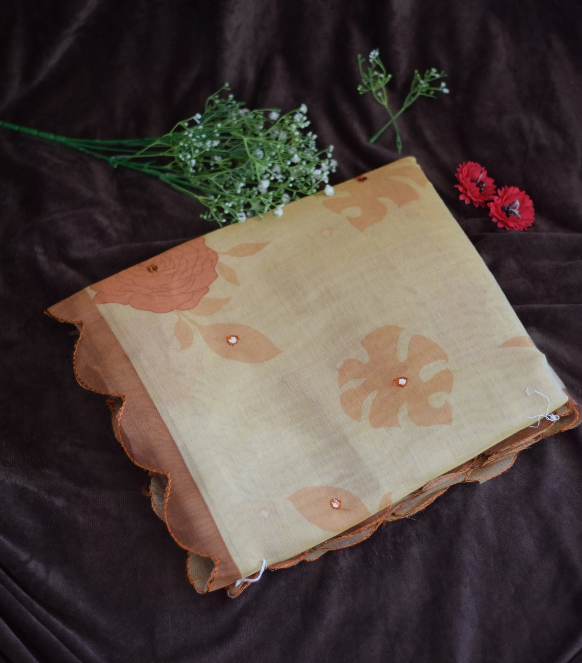 organza cotton saree  with floral pattern on a dark background